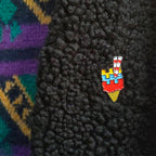 Colorful dublin-themed ice cream cone pin on a textured black surface with a multicolored pattern in the background.
