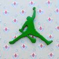 Green Hurler logo on a light blue background with floral patterns