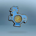 Blue rooster-shaped pin with gold liquid centre on a grey background
