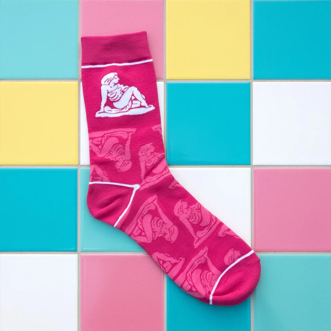 Pink sock with white lady / lady on the rock design on a colorful tiled background