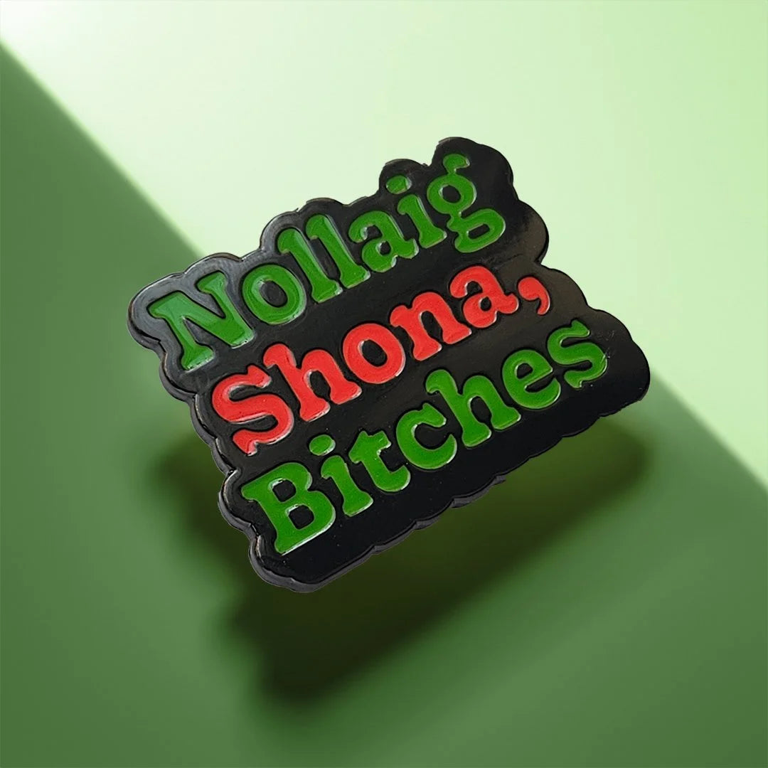 Decorative item with text 'Nollaig Shona, Bitches' on a green background