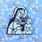 Enamel pin with a design of a woman holding a child and a glass of stout against a blue background with white snowflakes and branches.
