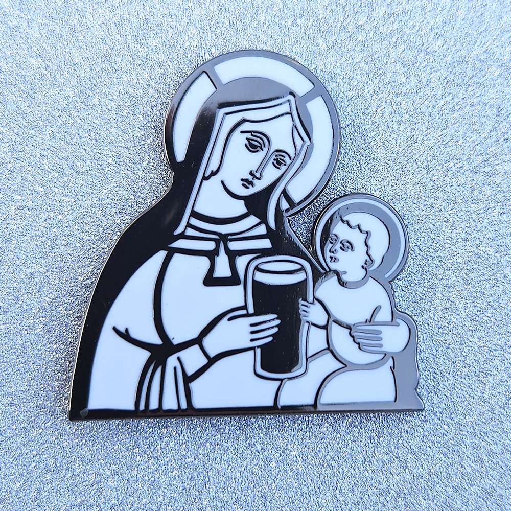 An illuminated manuscript depiction of 'Pint Baby' as a black and white enamel pin
