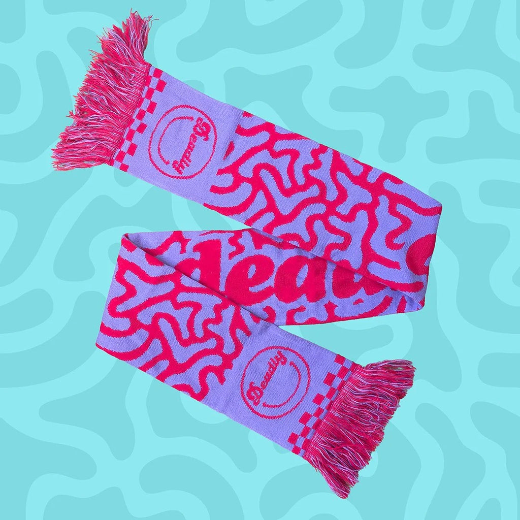 Pink and purple scarf with wavy pattern and deadly.ie logo on a blue background