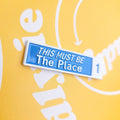 Blue sign with 'This Must Be The Place' text on a yellow background