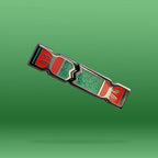 Decorative Christmas Cracker Pin with red and green design on a green background