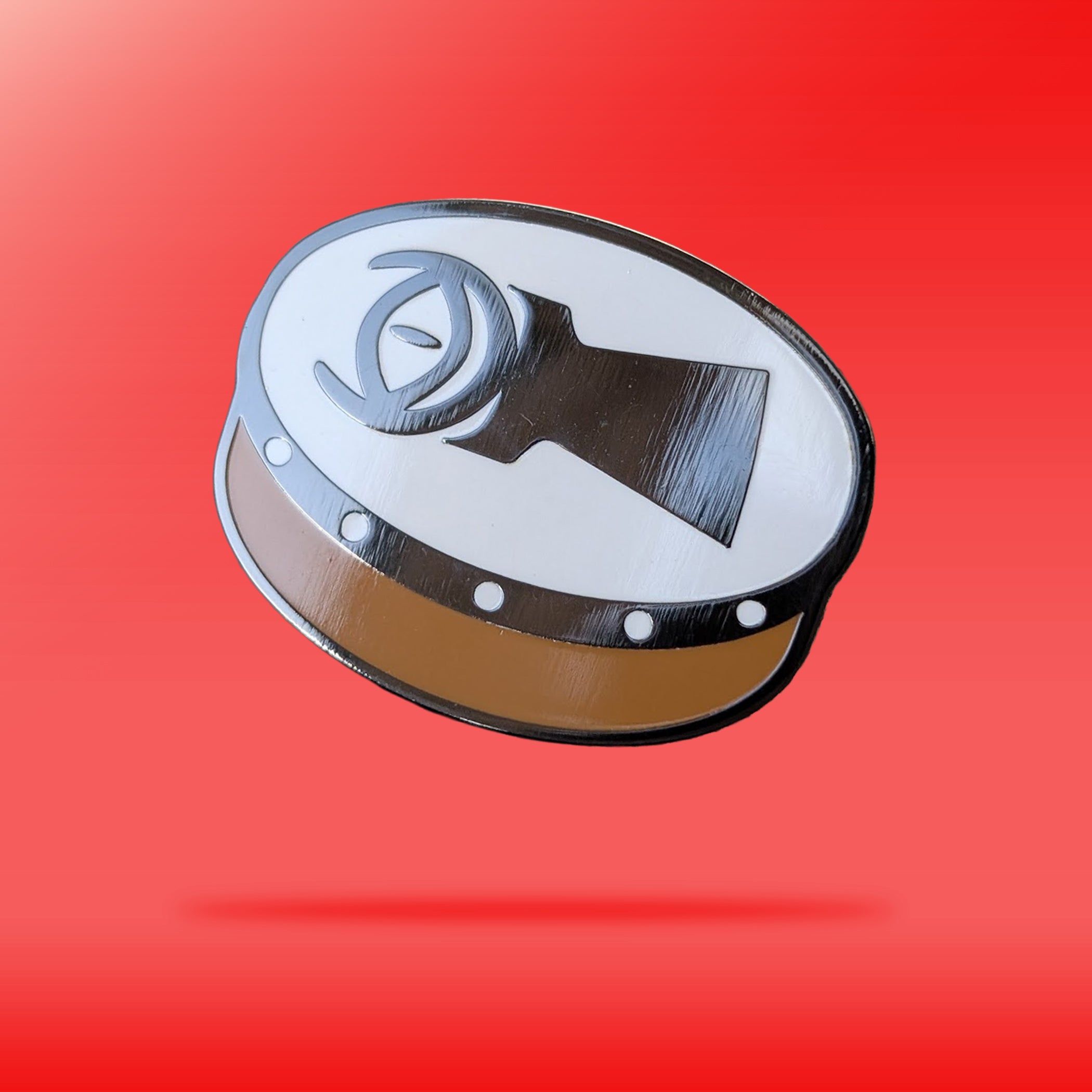 A pin depicting a bodhrán with an illustration of the Eye of Sauron on the front of it. 