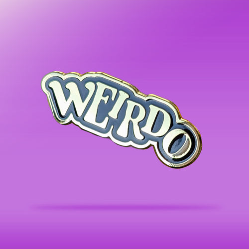 A black and Gold pin that reads 'weirdo' in offset text against a purple background
